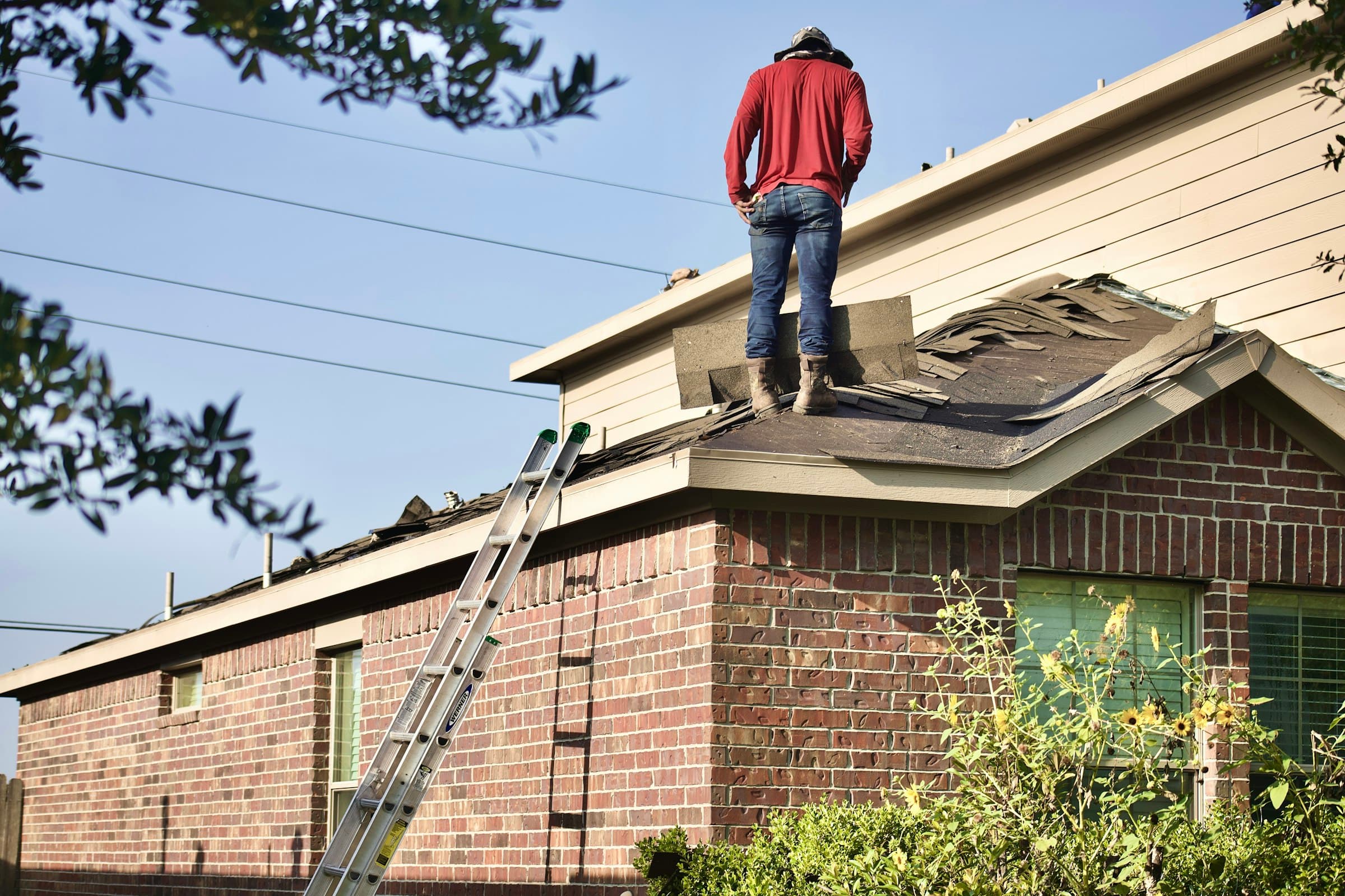 Professional roofing contractor working on residential roof